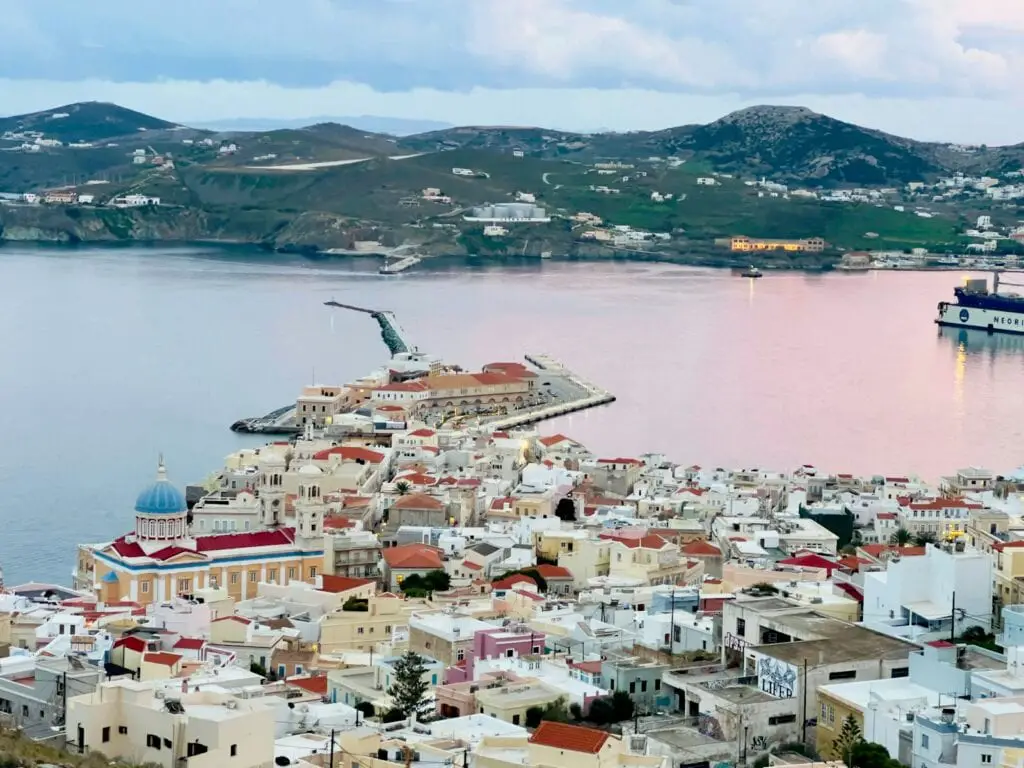 a large body of water surrounded by buildings, Greek islands near Mykonos